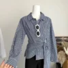 sg-11134201-7rd3t-m6xr261i4hl8c6.webp Korean Style Waist Controlled Lace up Loose Striped Shirt Women Unique Elegant Long Sleeve Shirt Blouse Women